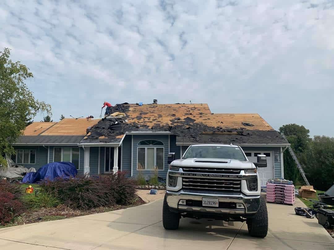 house roof being renovated with large truck in driveway. Residential Roofing Dane County, WI